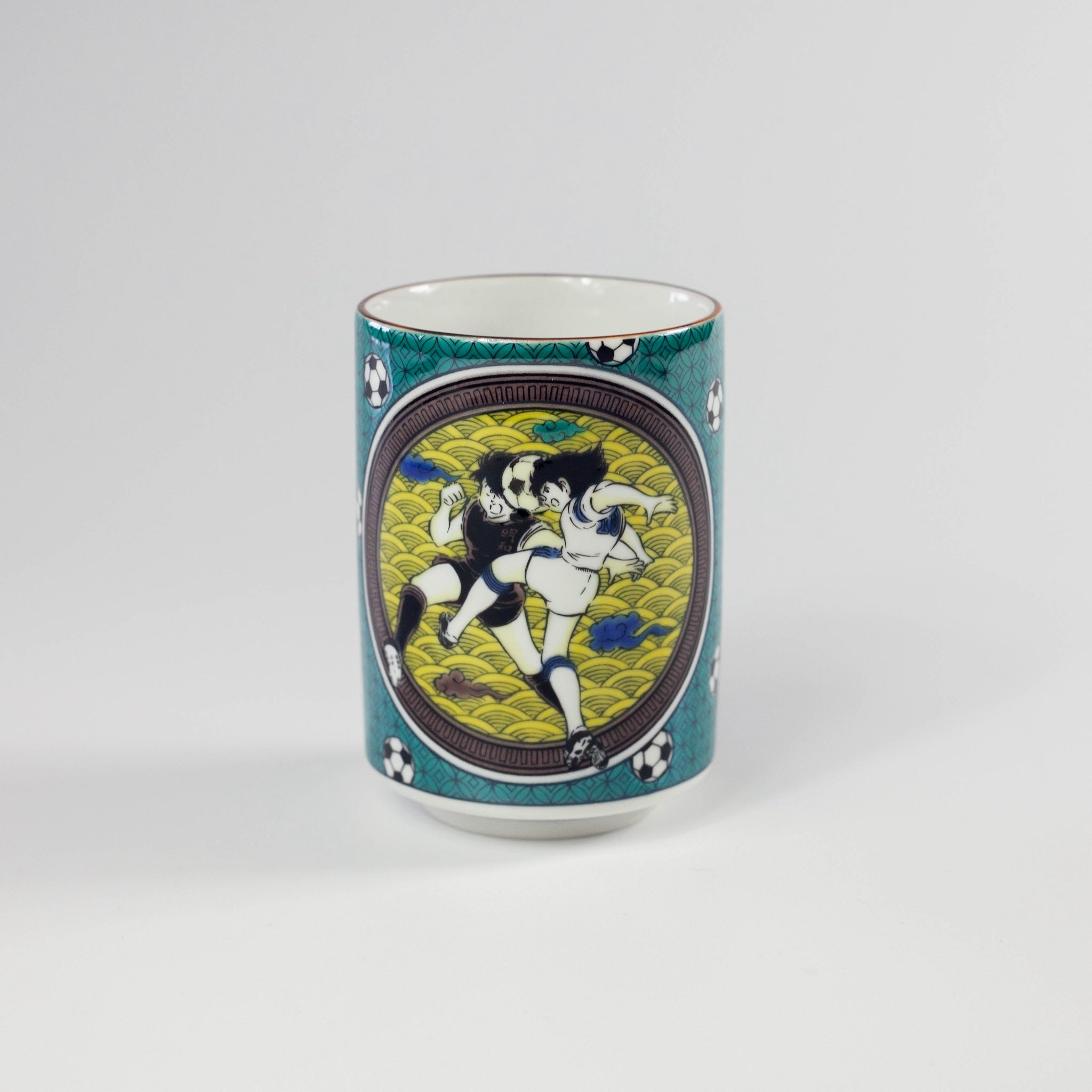 Green ceramic mug with artistic design on a white background