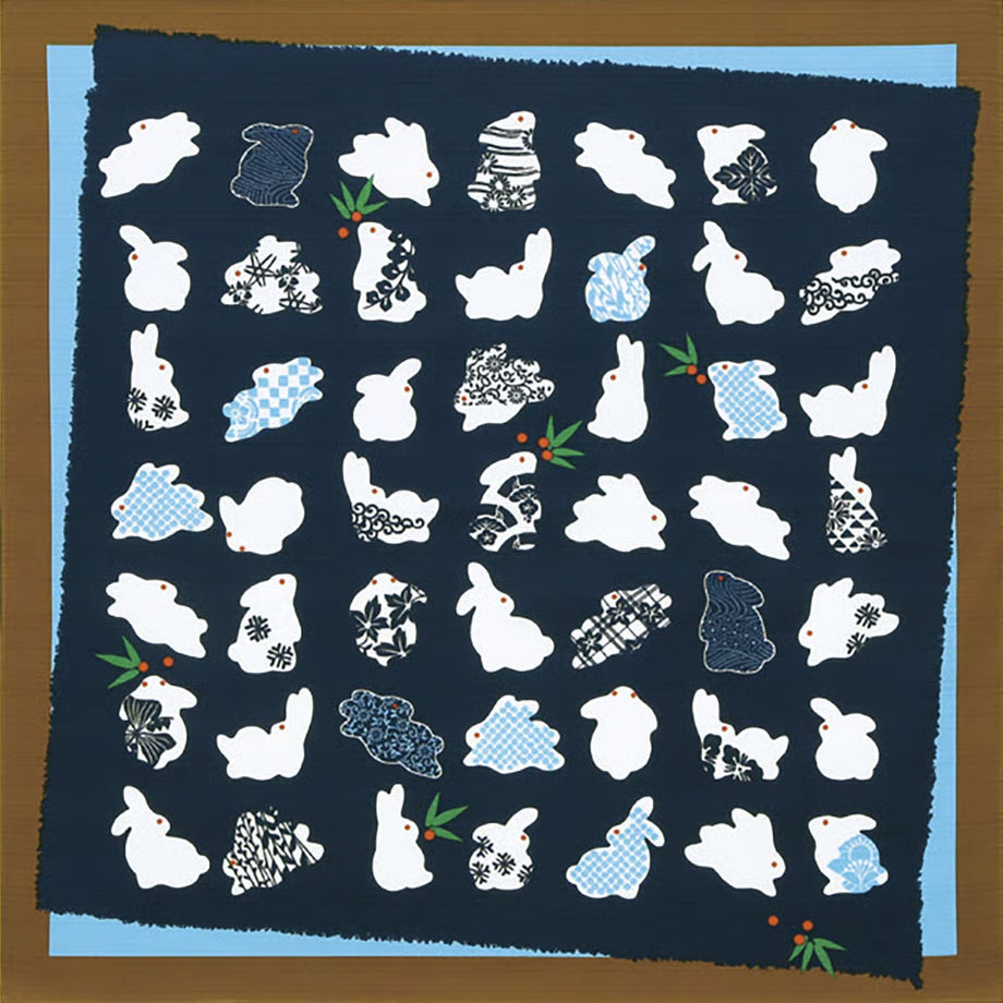 Blue and brown Japanese cotton furoshiki cloth featuring white rabbit silhouettes decorated with traditional komon geometric patterns