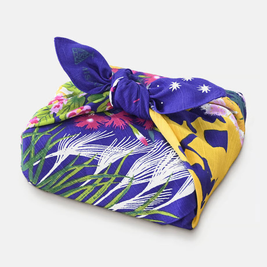 Colorful fabric wrap with floral and abstract patterns on a white background