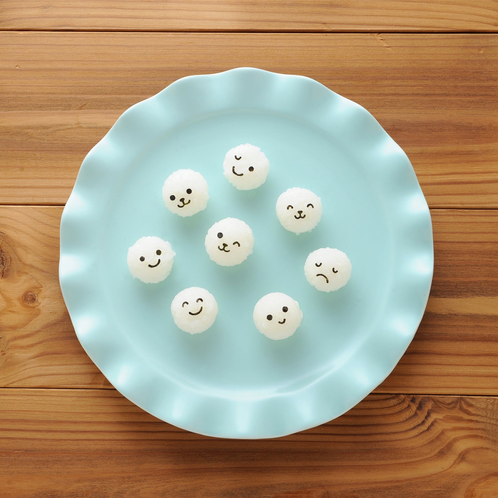 Arnest Baby Onigiri Rice Mold Set "Komusubi Ball Mini x2" retail packaging – yellow mold and two nori punches on a colorful Japanese card with product photos, on white background