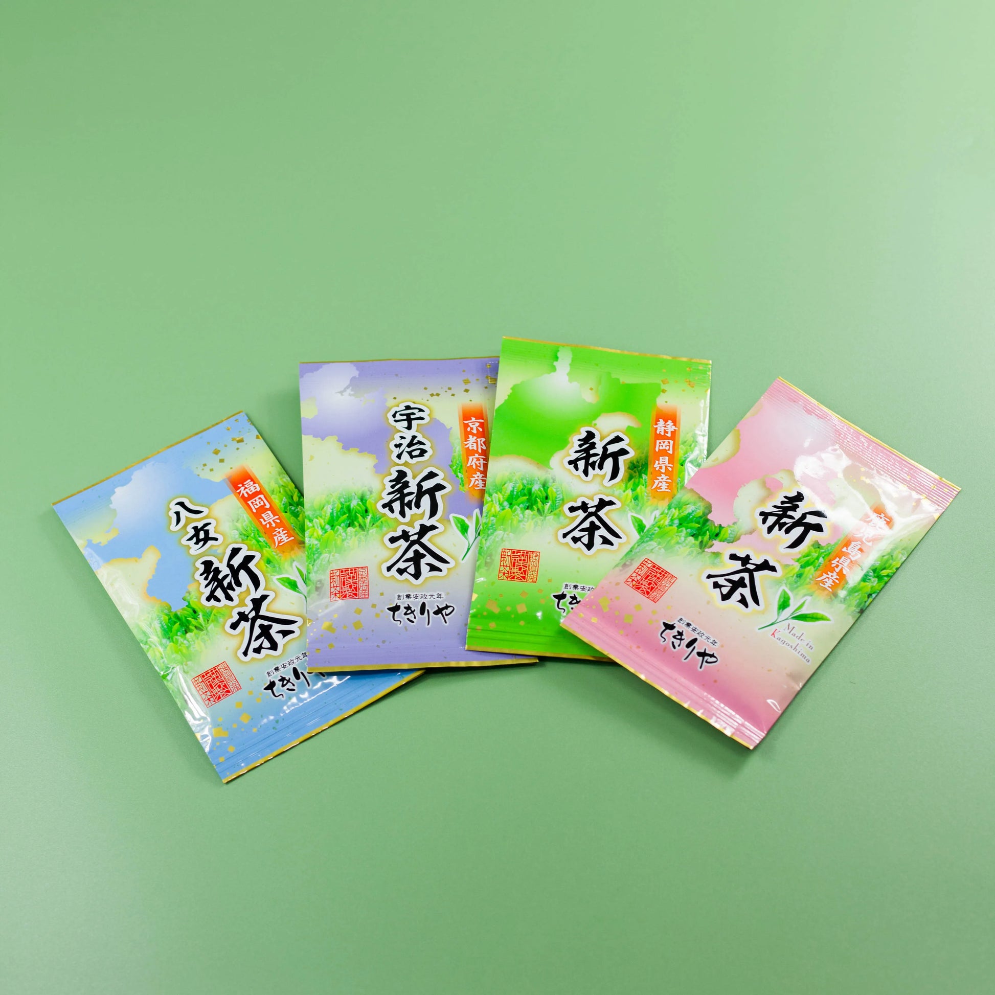 Four bags of seasonal Japanese Shincha green tea from Shizuoka, Kagoshima, Uji, and Yame on a green background.