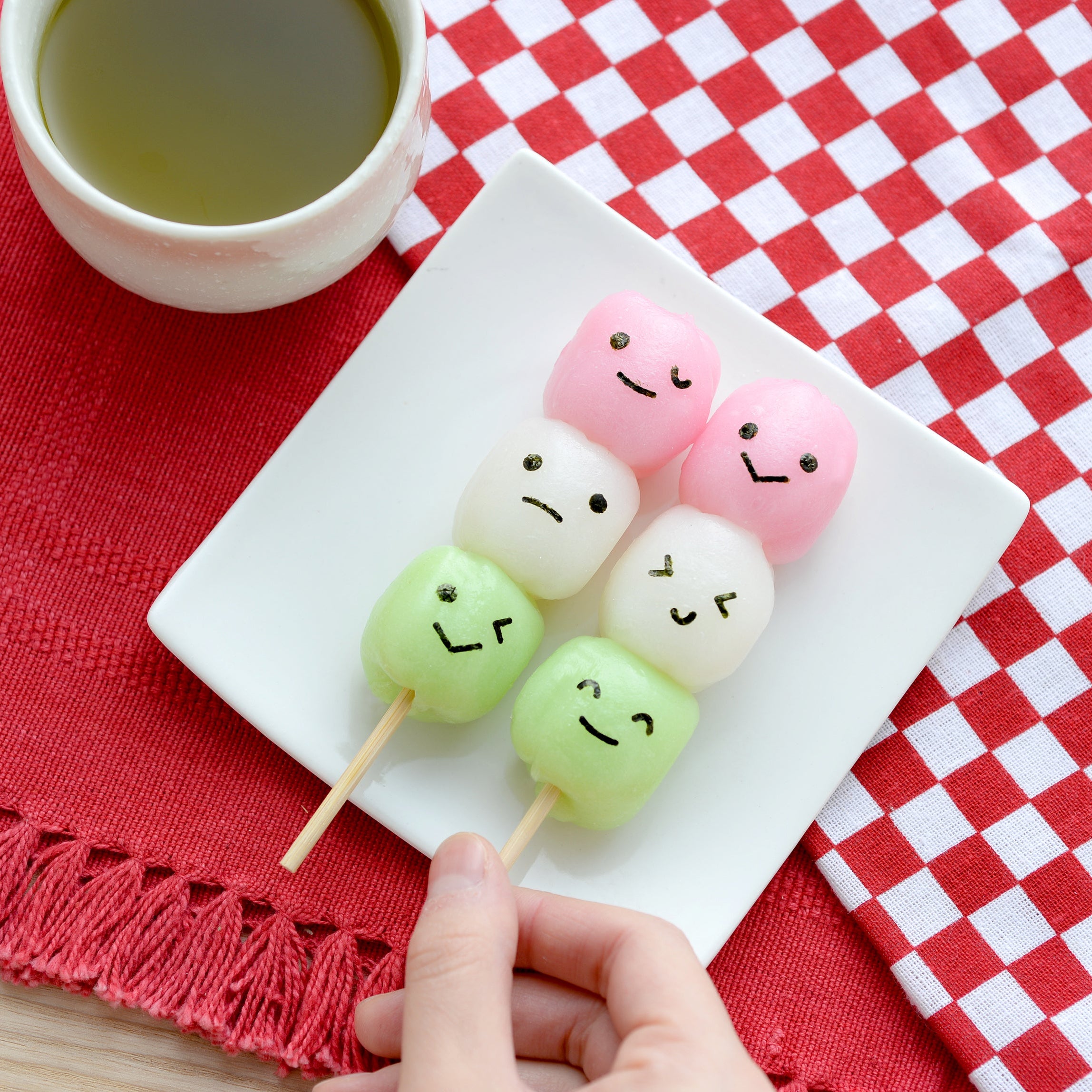 Arnest Nico Nico Nori Puncher Mini x2 retail packaging – three white square nori punches with pink, yellow, and teal emoji-face buttons on a colorful Japanese dango
