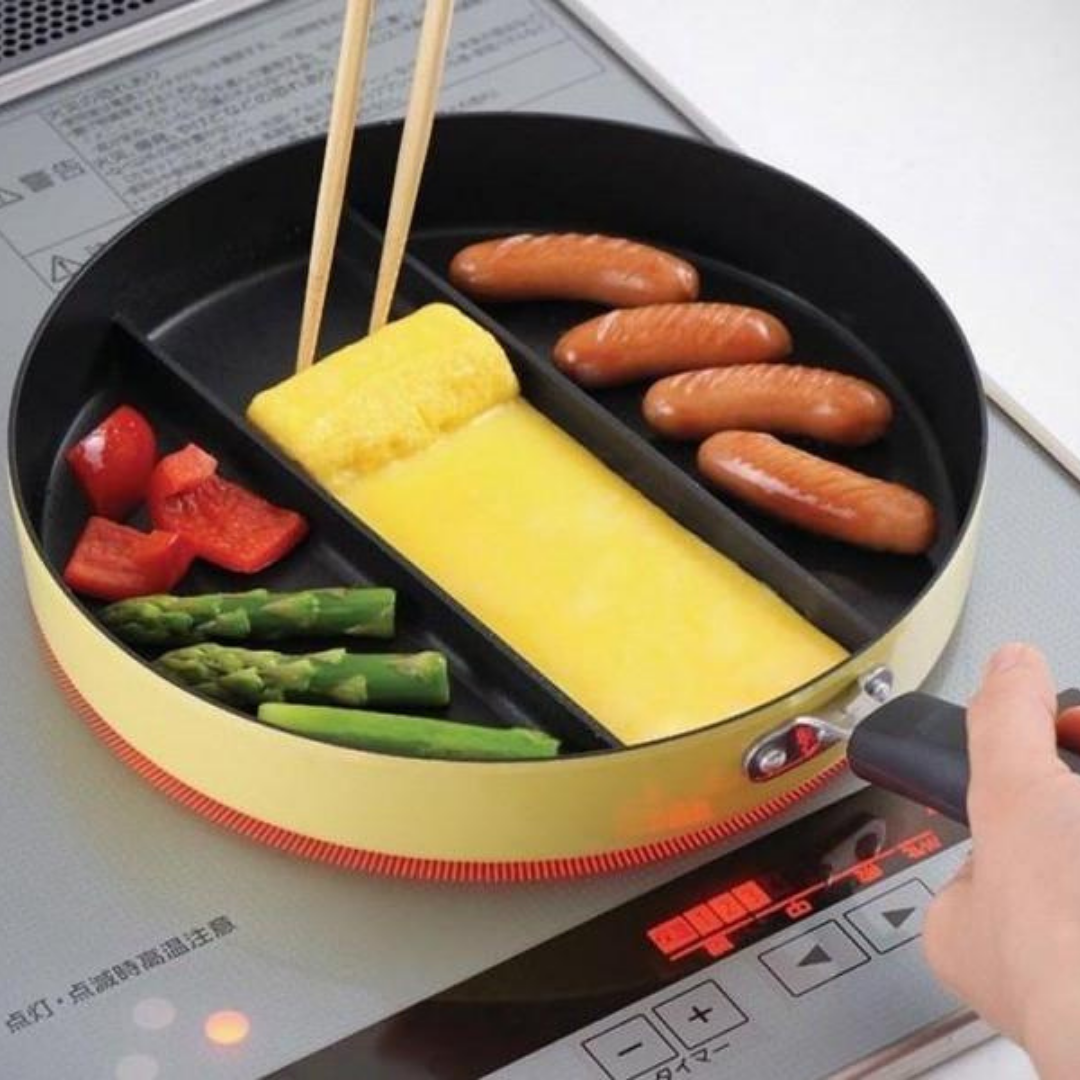 Triple Pan yellow divided frying pan on induction hob – cooking fluffy omelette, grilled sausages, red bell pepper, and asparagus simultaneously in three sections, hand adjusting induction settings